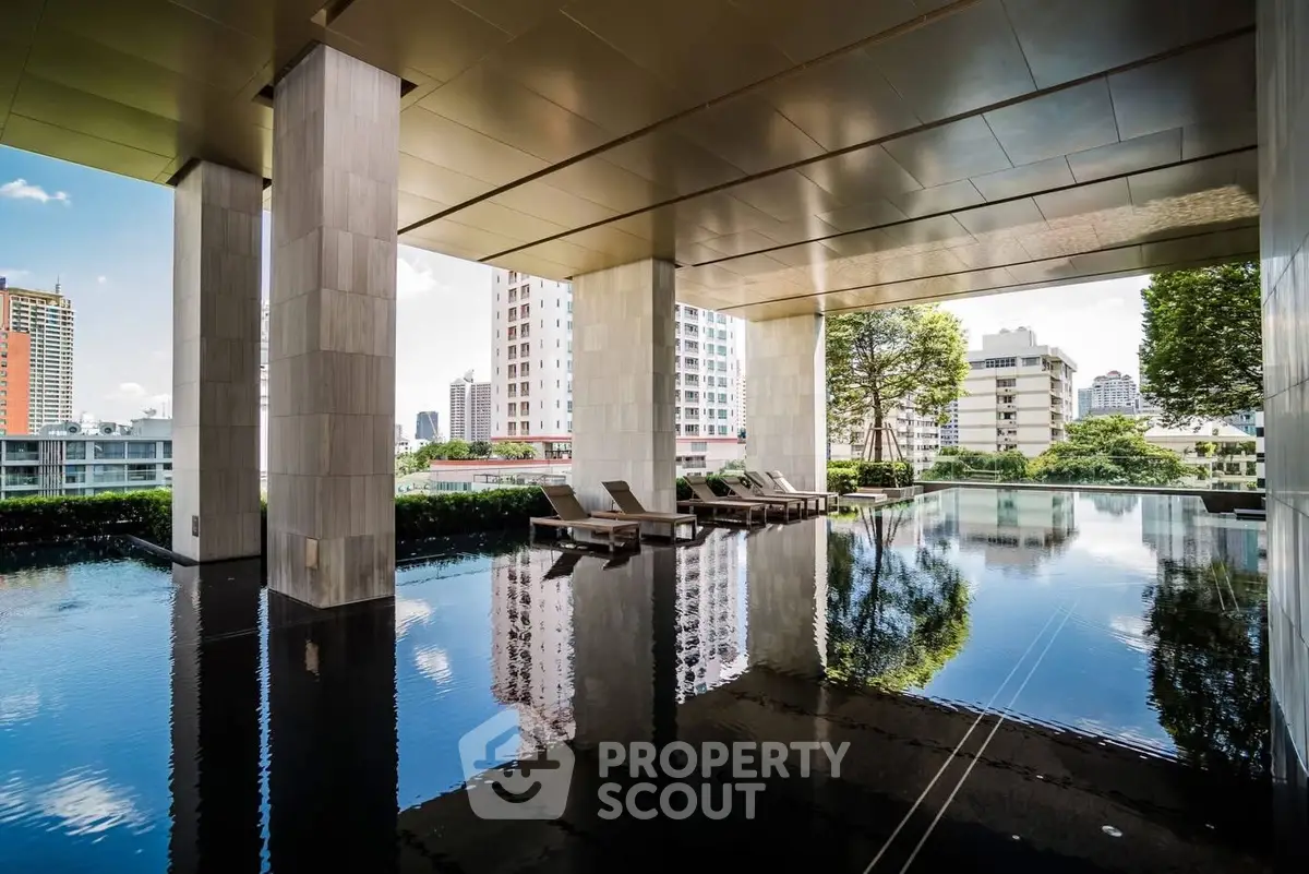 Luxurious high-rise building with stunning pool and city views, perfect for urban living.