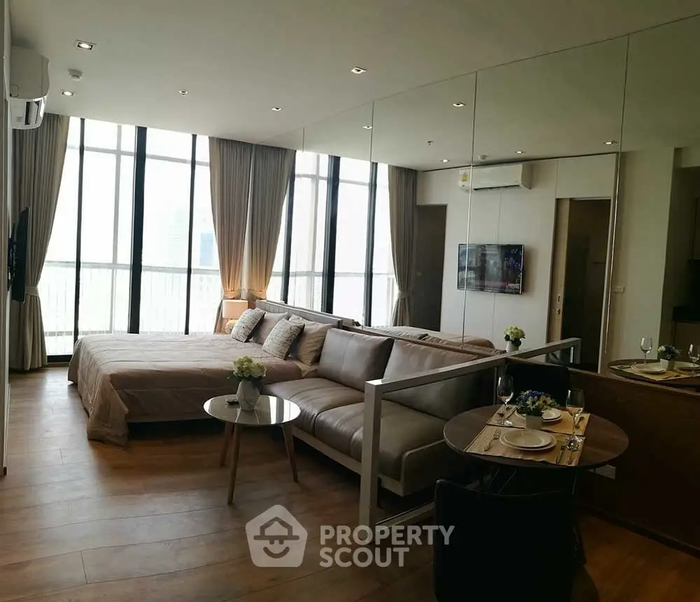 Luxurious studio apartment with modern open layout and floor-to-ceiling windows.