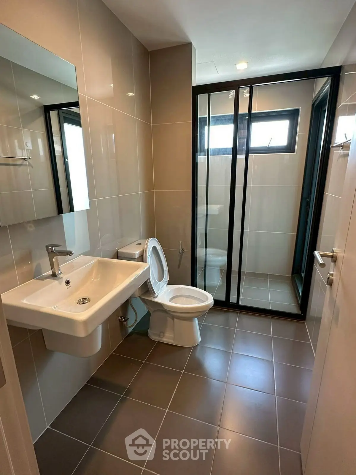 Modern bathroom with sleek fixtures and glass shower enclosure