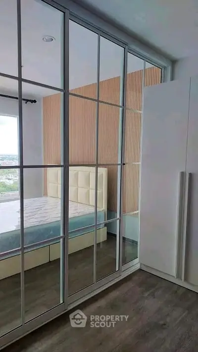 Modern bedroom with mirrored wardrobe and stylish wood paneling