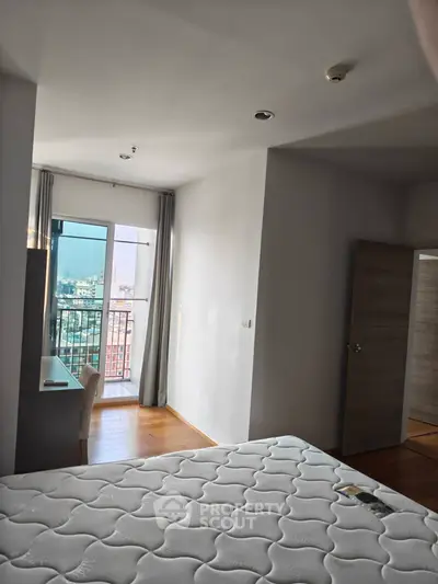 Modern bedroom with balcony view in high-rise apartment