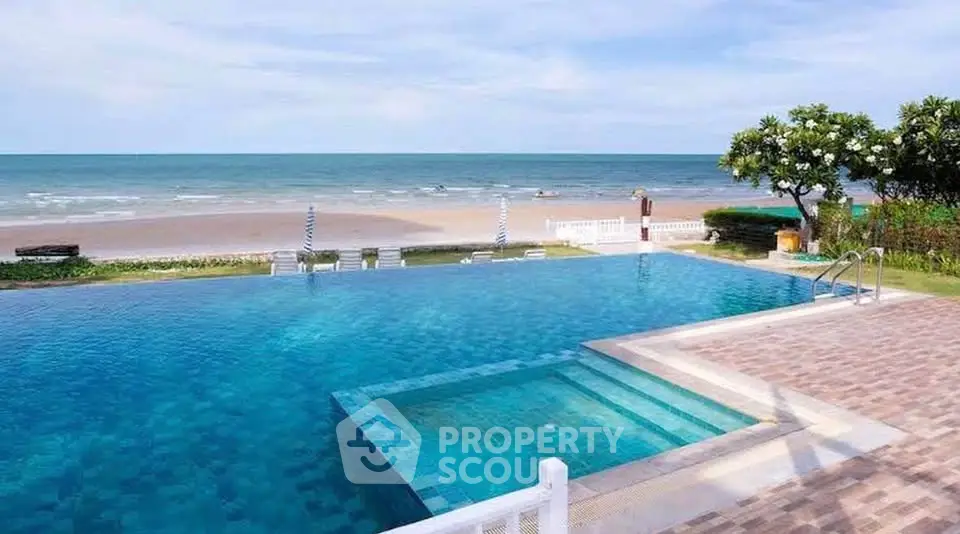 Stunning beachfront pool with ocean view, perfect for luxury living and relaxation.