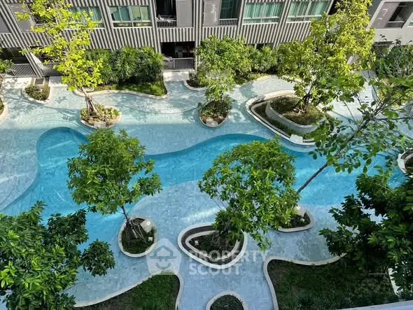 Luxurious residential complex with stunning outdoor pool and lush greenery
