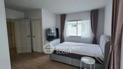 Spacious bedroom with modern decor and natural light