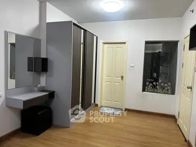 Modern bedroom with sleek wardrobe and vanity in a cozy apartment