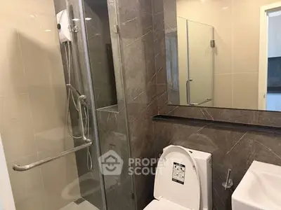 Modern bathroom with glass shower and sleek fixtures