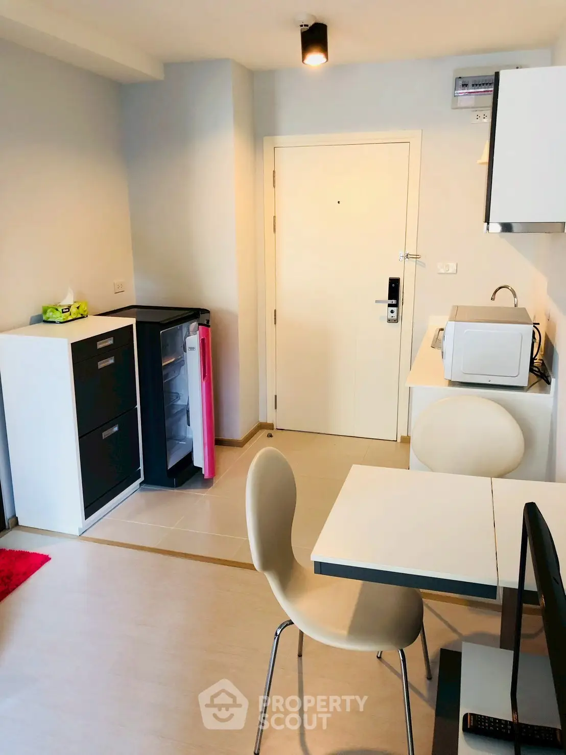 Modern compact kitchen with dining area in stylish apartment