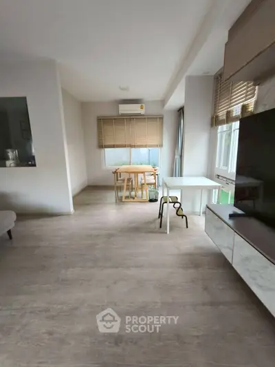 Modern living room with wooden flooring and stylish dining area