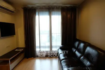 Cozy living room with leather sofa and large window for natural light