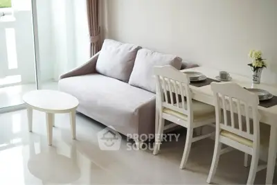 Chic modern living room with cozy sofa and elegant dining set near balcony