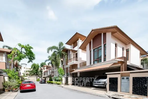 Charming suburban street with modern two-story homes and lush greenery