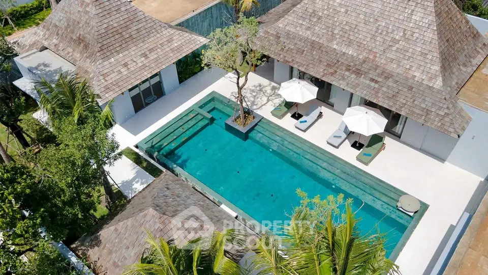 Luxurious villa with private pool and tropical landscaping, perfect for serene living.