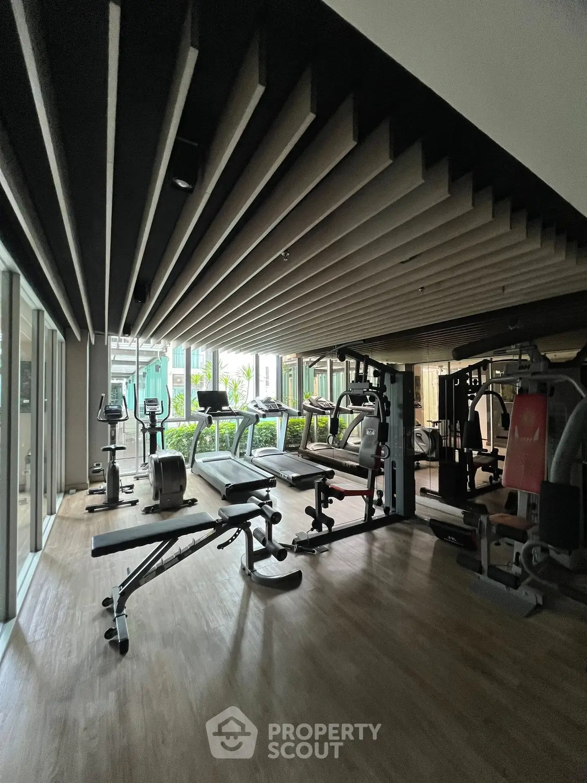 Modern gym with state-of-the-art equipment and sleek design in a luxury residential building.