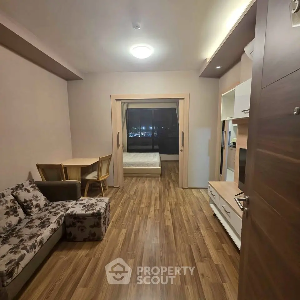 Modern studio apartment with cozy living area and separate bedroom space.