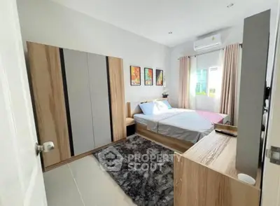 Modern bedroom with stylish decor and ample natural light