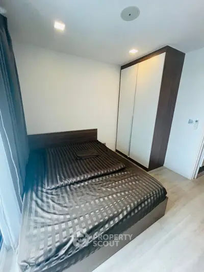 Modern bedroom with sleek wardrobe and stylish bed in contemporary apartment