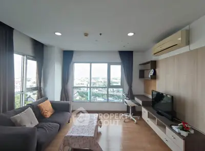 Spacious living room with panoramic city views and modern furnishings