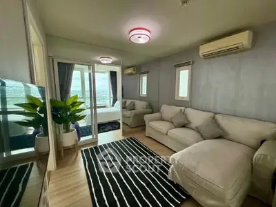 Modern living room with cozy sofas and large windows offering stunning views.