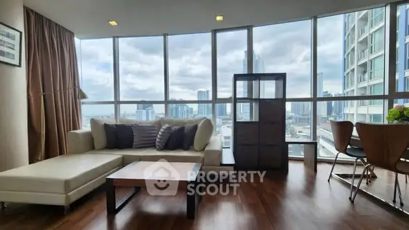Spacious living room with panoramic city view and elegant furnishings.