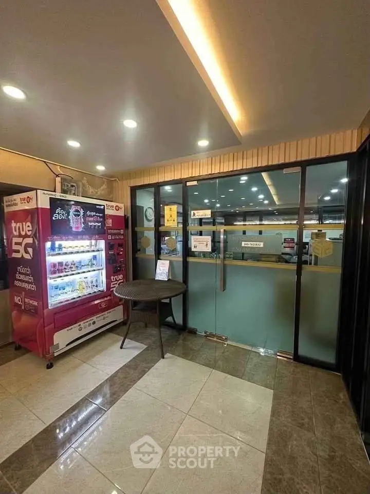 Modern building entrance with vending machine and glass doors