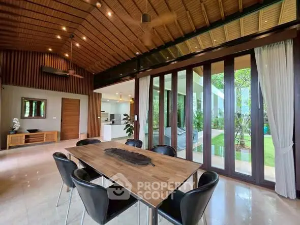 Luxurious dining area with garden view and modern wooden accents