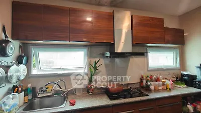 Modern kitchen with sleek cabinets and gas stove, ideal for culinary enthusiasts.