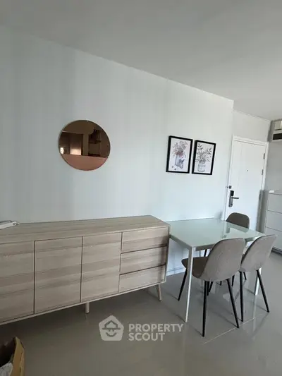 Modern dining area with sleek furniture and minimalist decor in a stylish apartment.