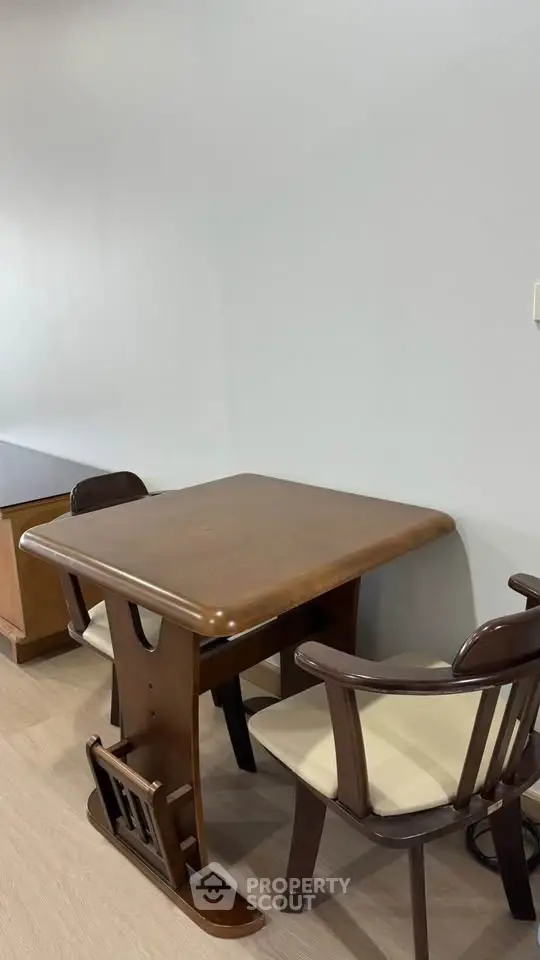Charming dining area with wooden table and chairs, perfect for cozy meals in a modern home.