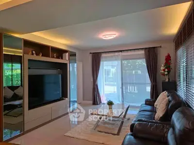Spacious living room with modern decor and large windows offering natural light.