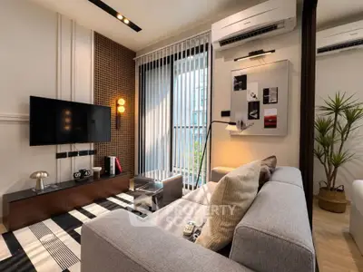 Modern living room with stylish decor, large sofa, and wall-mounted TV, perfect for relaxation and entertainment.