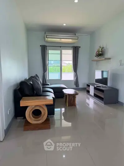 Modern living room with sleek furniture and natural light, perfect for relaxation and entertainment.