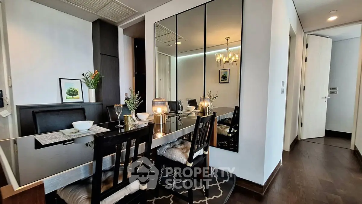 Elegant dining area with mirrored wall and modern decor in luxury apartment