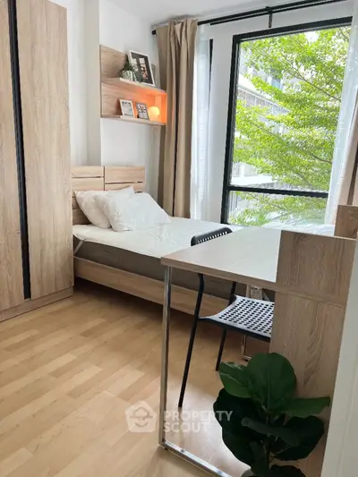 Cozy bedroom with natural light and modern wooden furniture