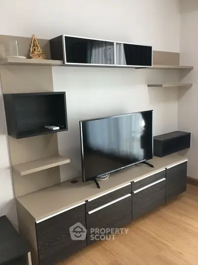 Modern living room with sleek TV stand and wall-mounted shelves