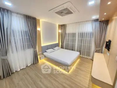 Modern bedroom with stylish lighting and elegant curtains