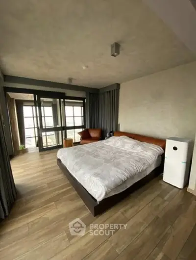 Spacious modern bedroom with large windows and stylish decor