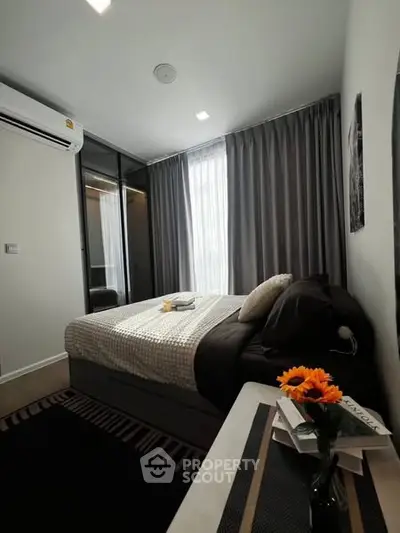 Cozy bedroom with modern decor, featuring a comfortable bed, stylish curtains, and a sleek air conditioning unit.