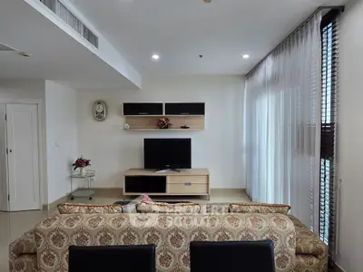 Elegant living room with stylish decor and modern entertainment center, perfect for relaxation and entertainment.