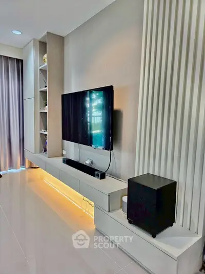 Modern living room with sleek TV setup and ambient lighting