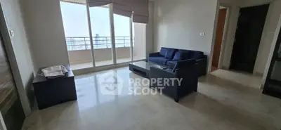 Spacious living room with modern furniture and large balcony view