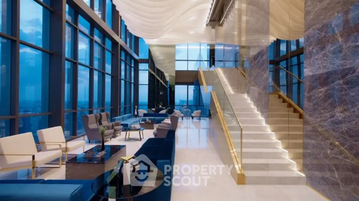 Luxurious high-rise living room with stunning city views and elegant staircase