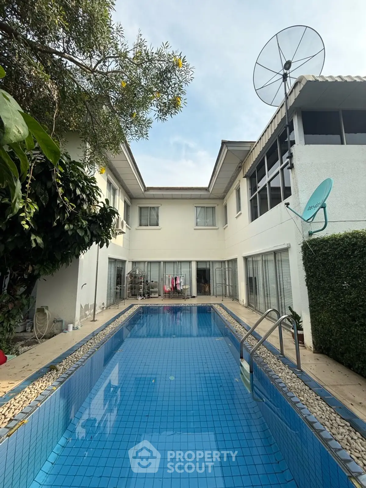 Stunning residential property with private pool and lush greenery, perfect for luxury living.