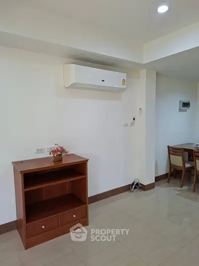 Modern apartment interior with air conditioning and wooden furniture