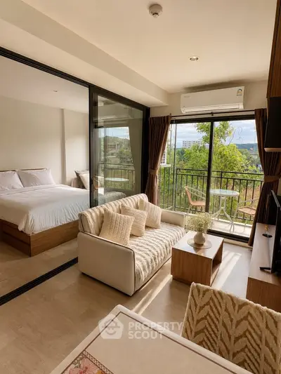 Modern open-plan living room with balcony view in a stylish apartment