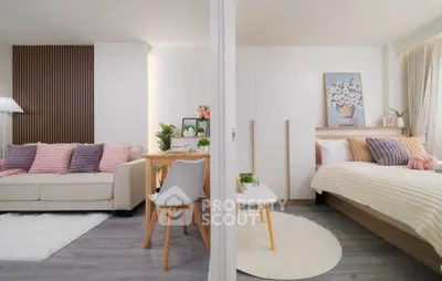 Modern studio apartment with stylish living area and cozy bedroom, featuring elegant decor and natural light.