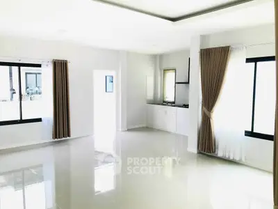 Spacious modern living room with large windows and sleek tile flooring