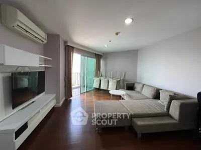 Spacious living room with modern furniture and balcony access