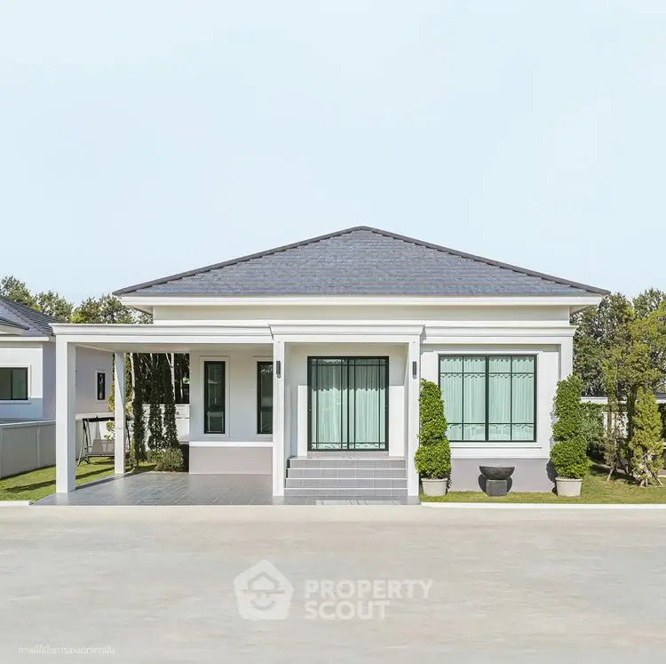 Charming single-story house with modern design and lush greenery.