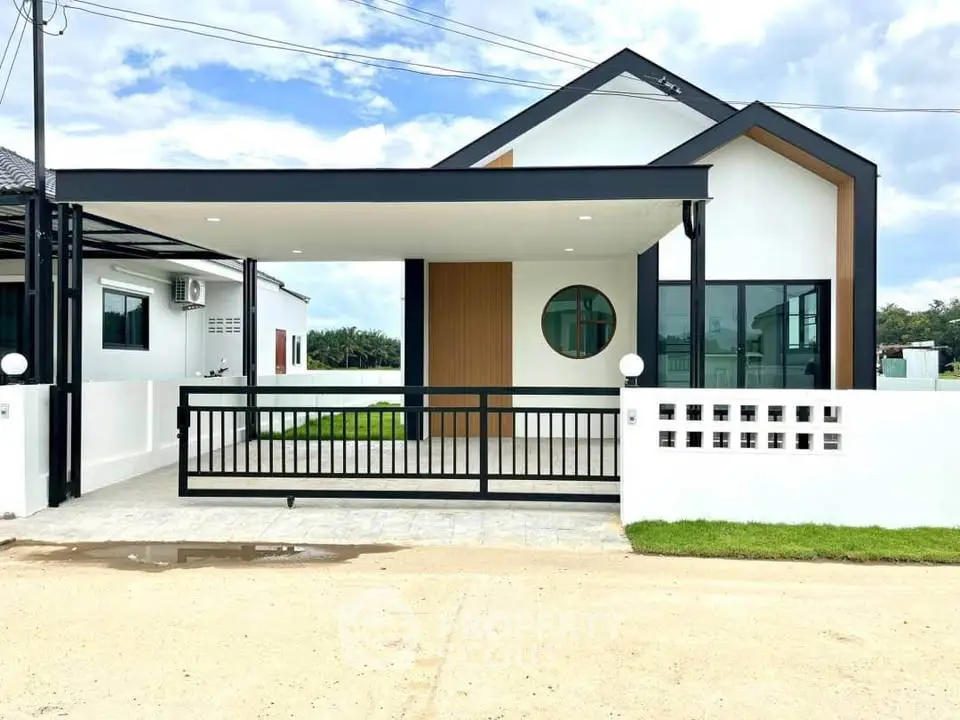Modern minimalist house exterior with sleek design and spacious driveway, perfect for contemporary living.