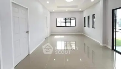 Spacious empty room with glossy tiled floor and large windows